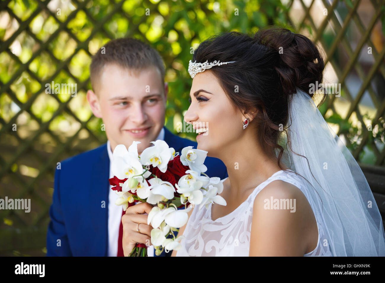 Wedding couple sitting in a wooden garden house Stock Photo