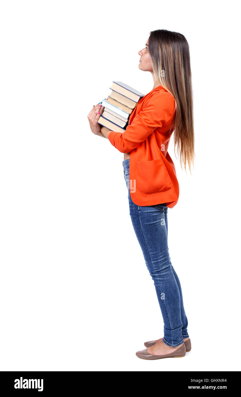 Girl carries a heavy pile of books. back view Stock Photo - Alamy