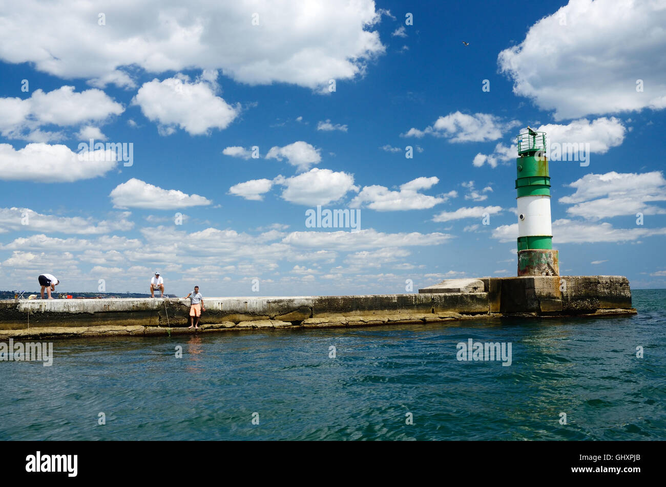 ILLICHIVSK,UKRAINE - JULY 21: Unidentified local people fishing at lighthouse of sea port in Illichivsk ,Ukraine on July, 21, 20 Stock Photo