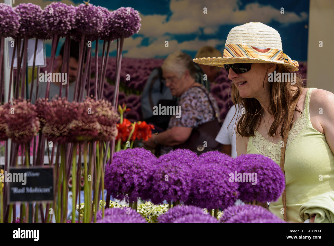 Young woman looking at a flower display at a flower show. Stock Photo