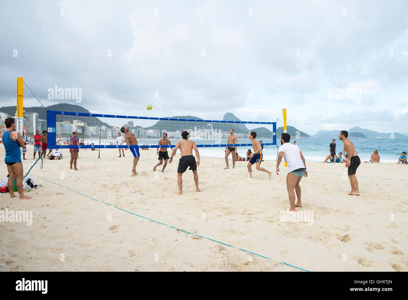 RIO DE JANEIRO - NOVEMBER 10, 2015: Young Brazilian men play a game of footvolley, a sport that combines football and volleyball Stock Photo