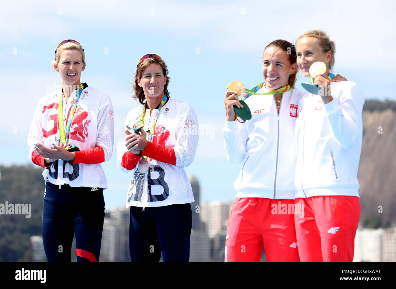 Great Britain's Katherine Grainger and Victoria Thornley with their silver medals as Poland (right) celebrate gold following the women's doubles sculls final A at the Lagoa Stadium on the sixth day of the Rio Olympics Games, Brazil. Stock Photo