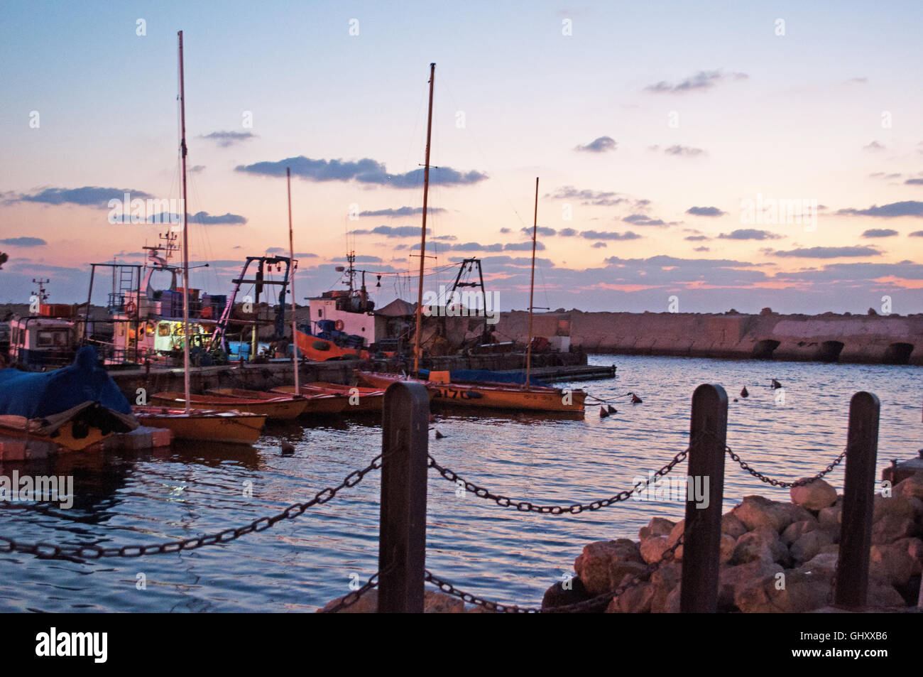 Israel, Middle East: sunset and fishing boats at the port of Old Jaffa, the oldest part of Tel Aviv Yafo, a fishermen village Stock Photo