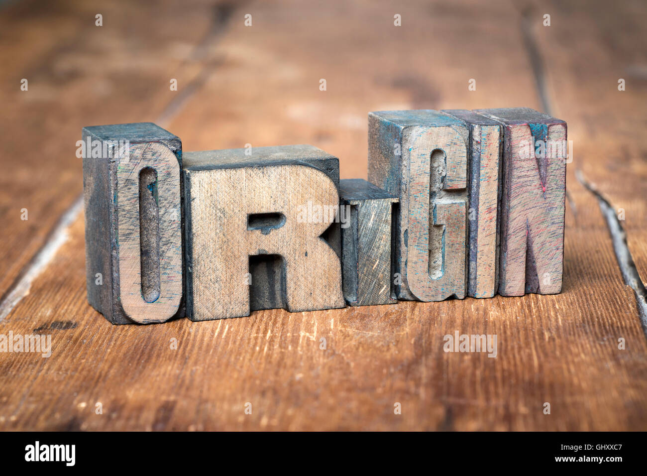 origin word made from wooden letterpress type on grunge wood Stock Photo