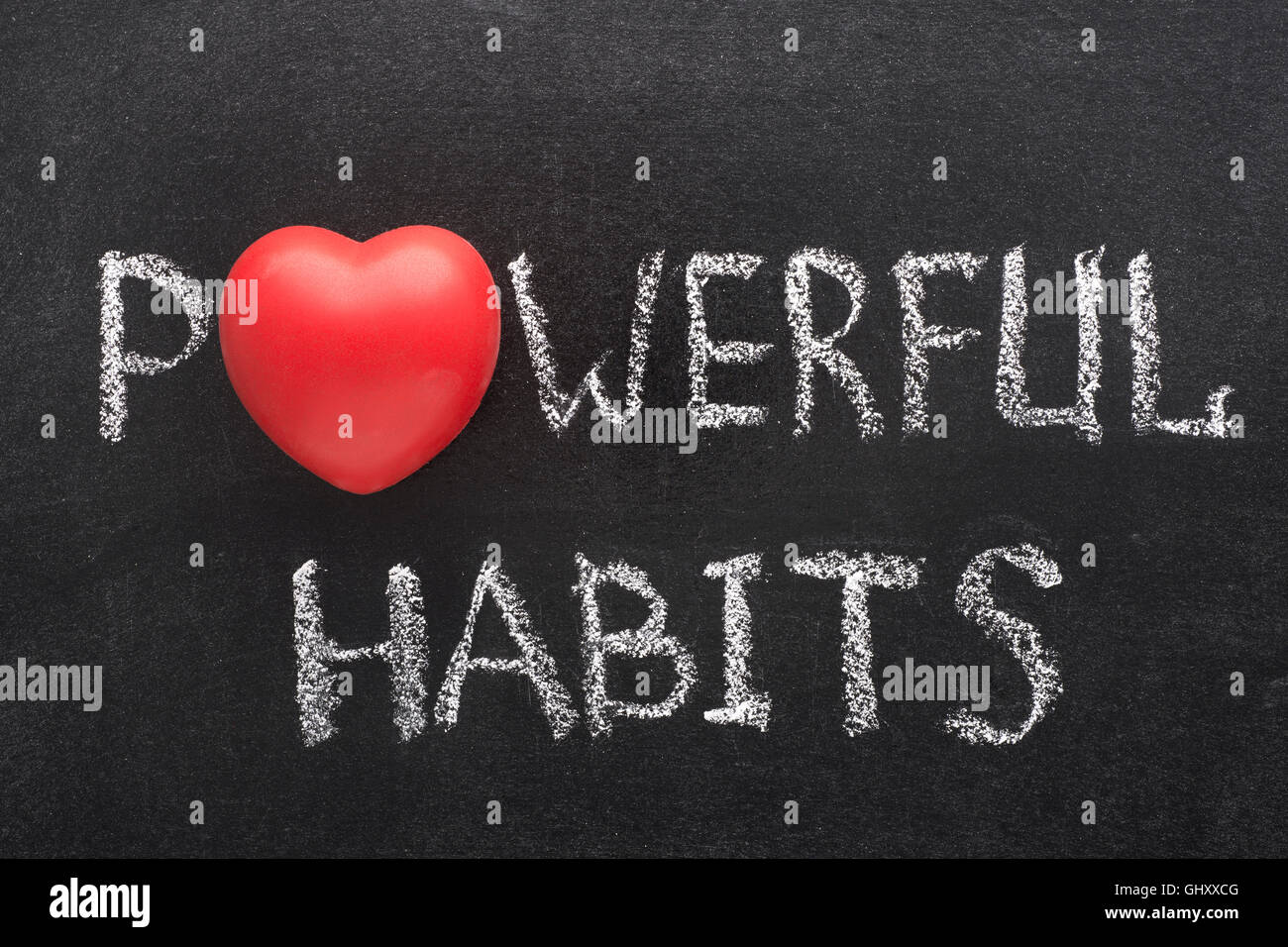 powerful habits phrase handwritten on blackboard with heart symbol instead of O Stock Photo