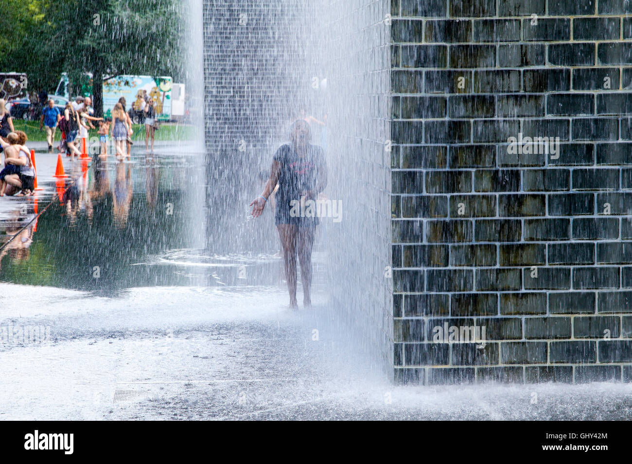 Young girl playing in Crown Fountain. Millennium Park, Chicago, Illinois. Stock Photo