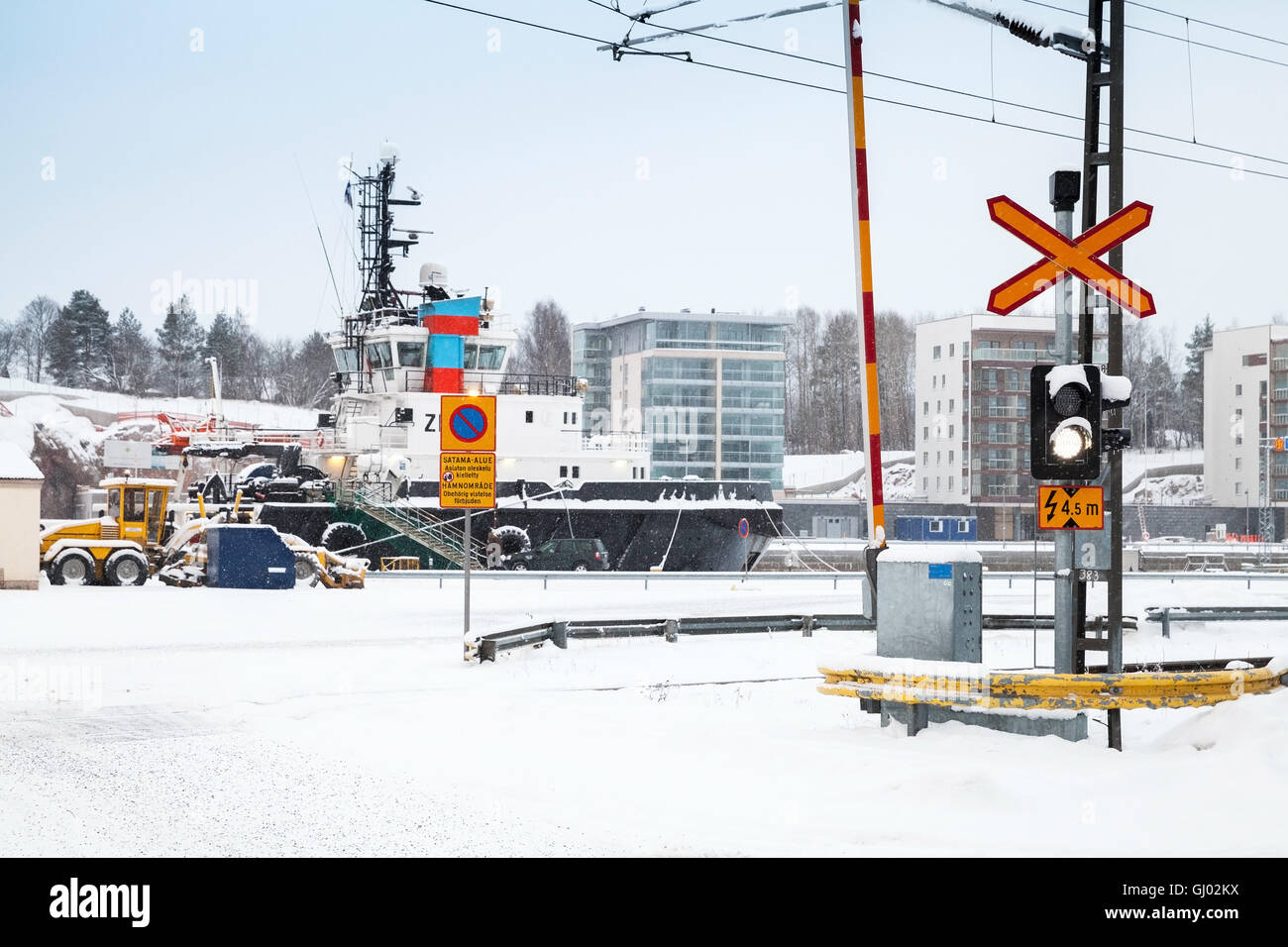 Turky, Finland - January 17, 2016: Railroad crossing near port in snowy winter day Stock Photo