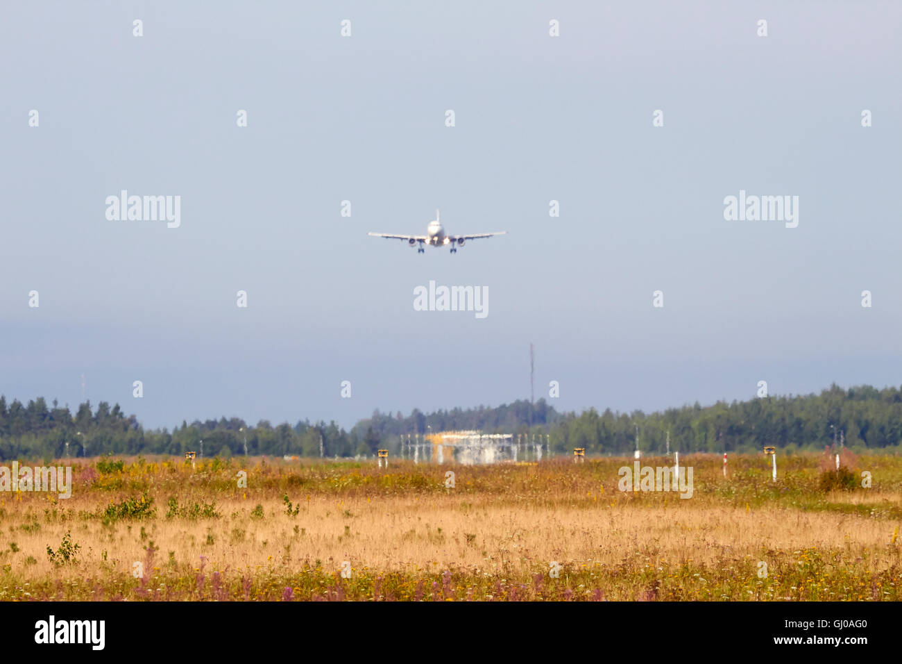 heat haze blurred Finnair Airbus A320 landing Stock Photo