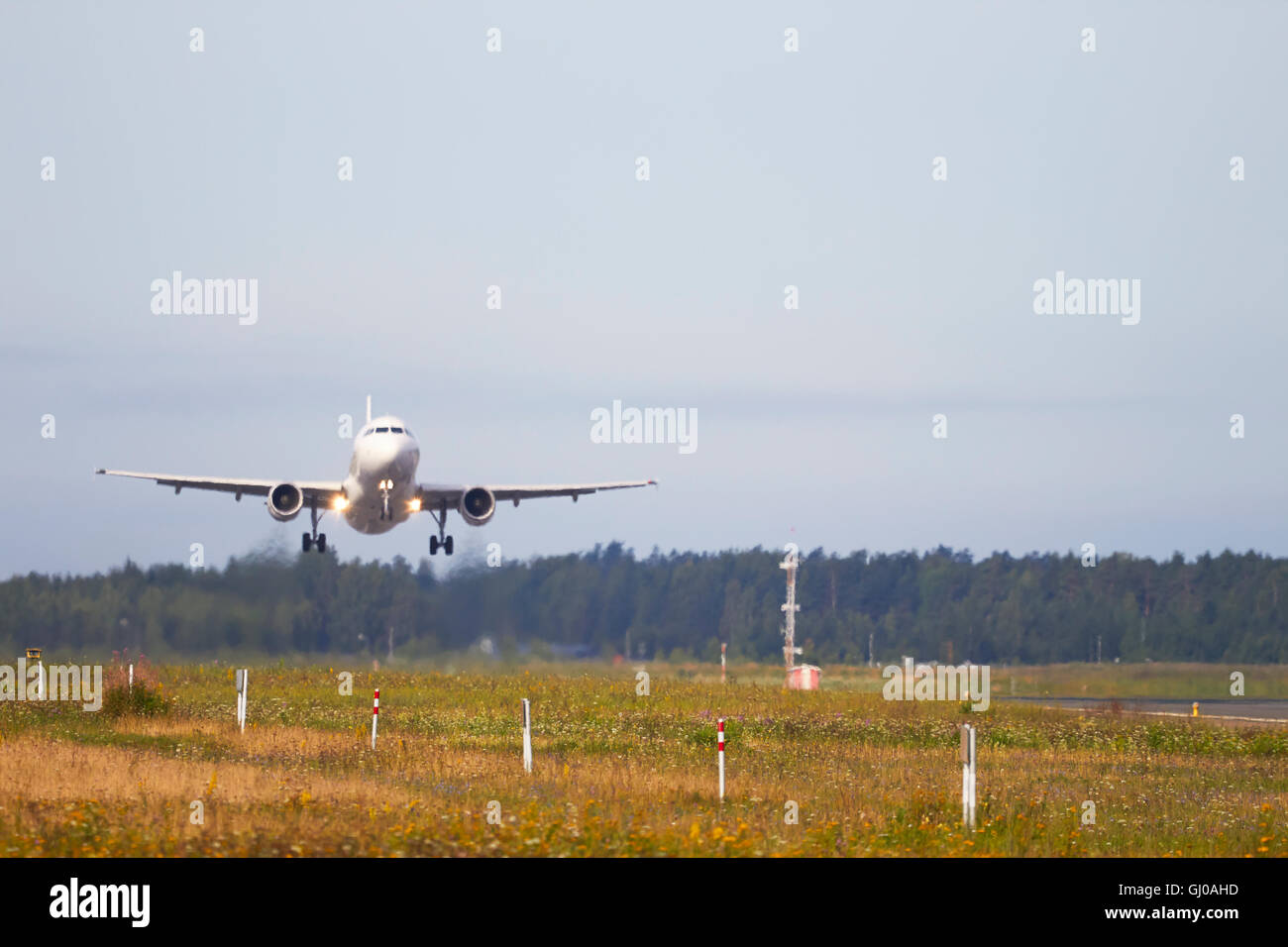 heat haze blurred Finnair Airbus A320 take-off Stock Photo