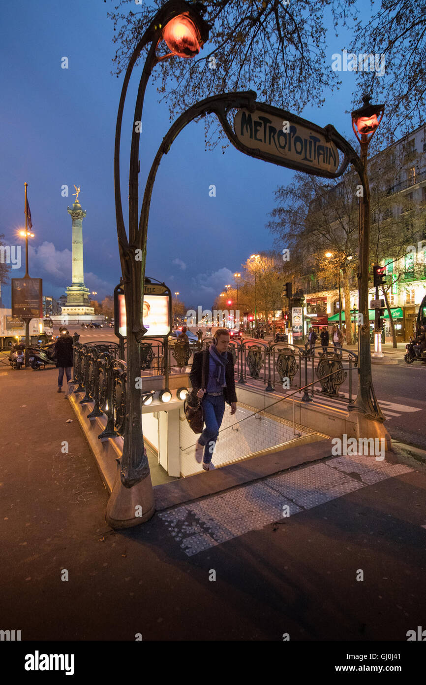 A person at the entry to the Metro in the Place de la Bastille at dusk, Paris, France Stock Photo