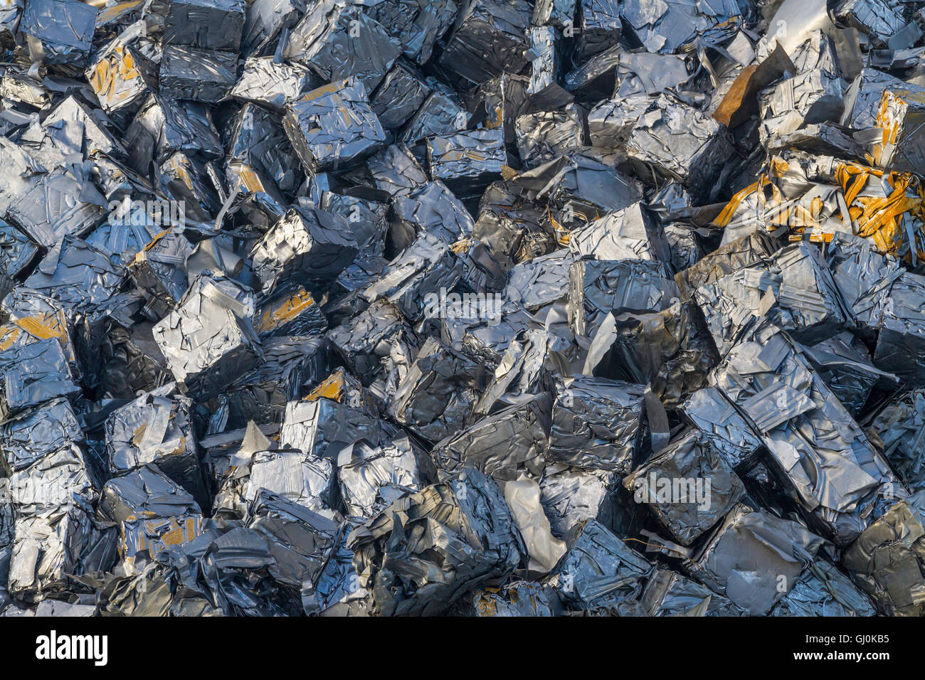 Close up of a pile of crushed cars all reduced to cubes of metal Stock Photo