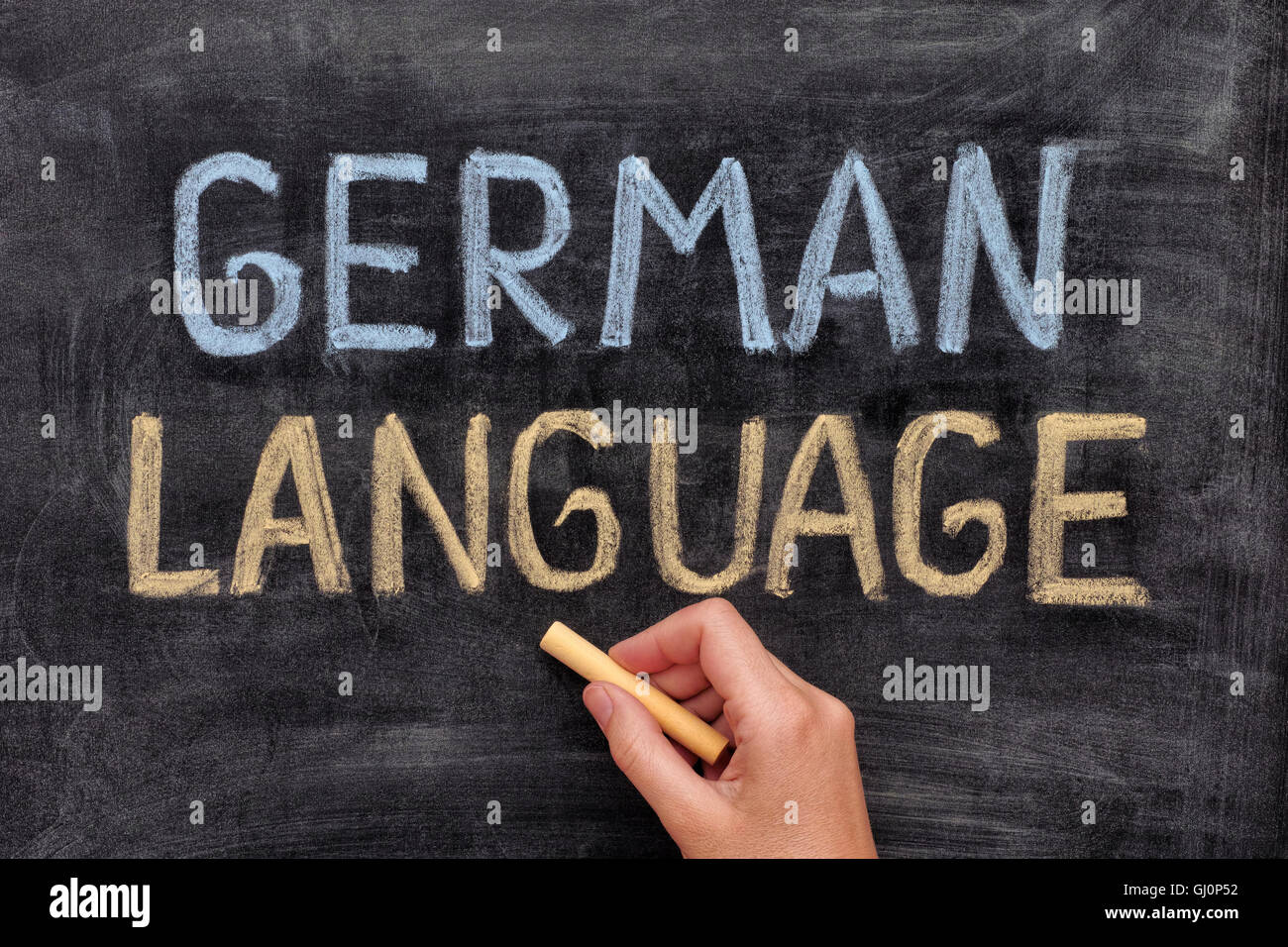 German language. Hand drawing German Language on blackboard. Close up ...