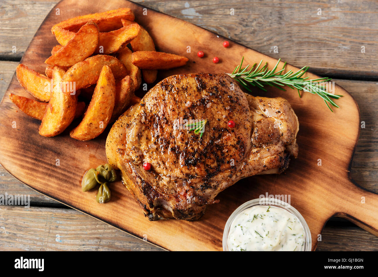 steak on the bone steak with baked potato and gravy Stock Photo - Alamy
