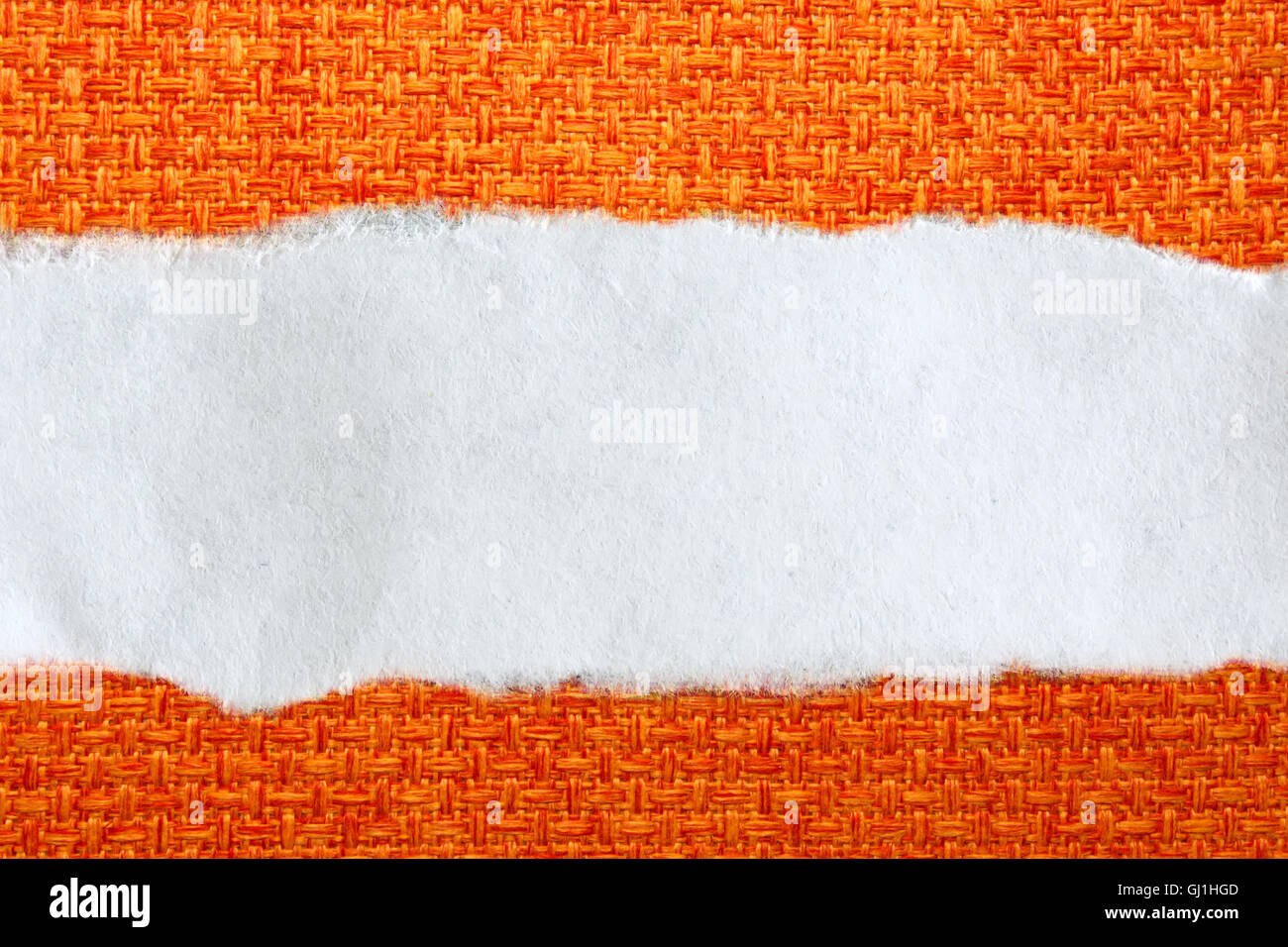 Ragged piece of paper on orange background Stock Photo - Alamy