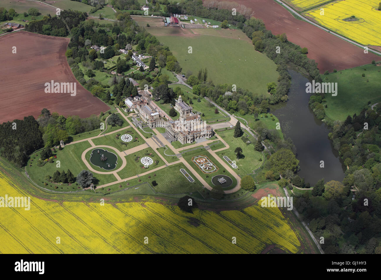 Aerial views of English Heritage Witley Court and gardens near Great Witley set amongst the yellow rapeseed fields of the Worcesterhire countryside Stock Photo