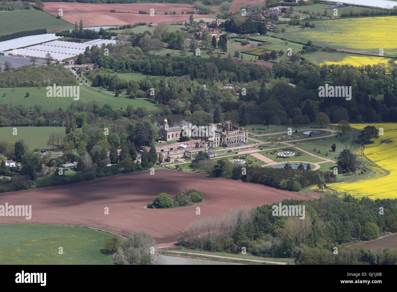Aerial views of English Heritage Witley Court and gardens near Great Witley set amongst the yellow rapeseed fields of the Worcesterhire countryside Stock Photo