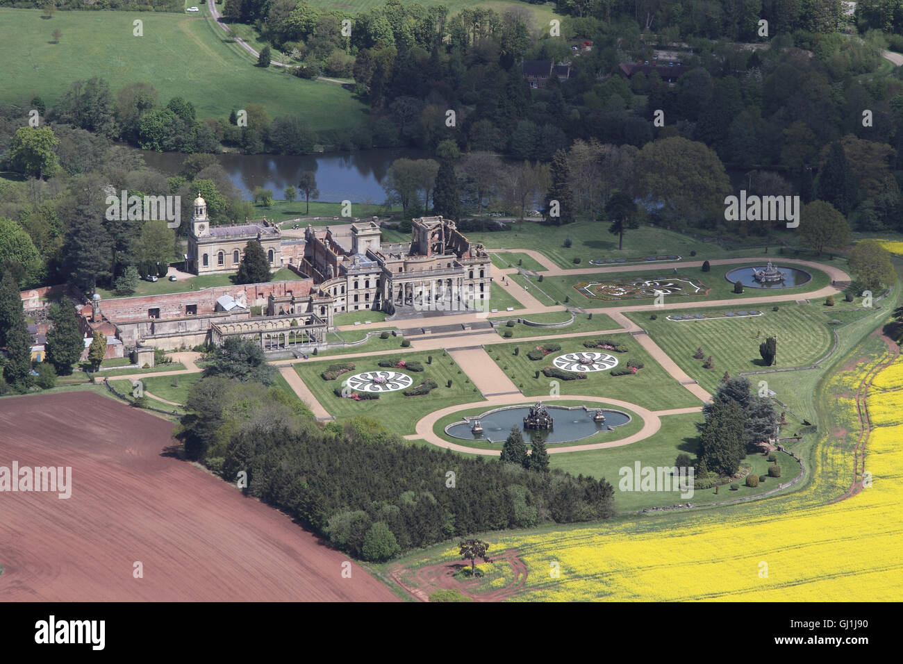 Aerial views of English Heritage Witley Court and gardens near Great Witley set amongst the yellow rapeseed fields of the Worcesterhire countryside Stock Photo