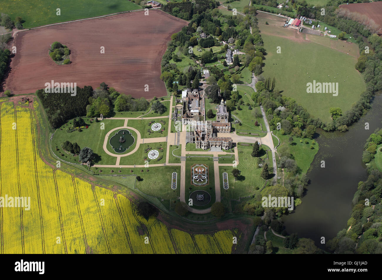 Aerial views of English Heritage Witley Court and gardens near Great Witley set amongst the yellow rapeseed fields of the Worcesterhire countryside Stock Photo