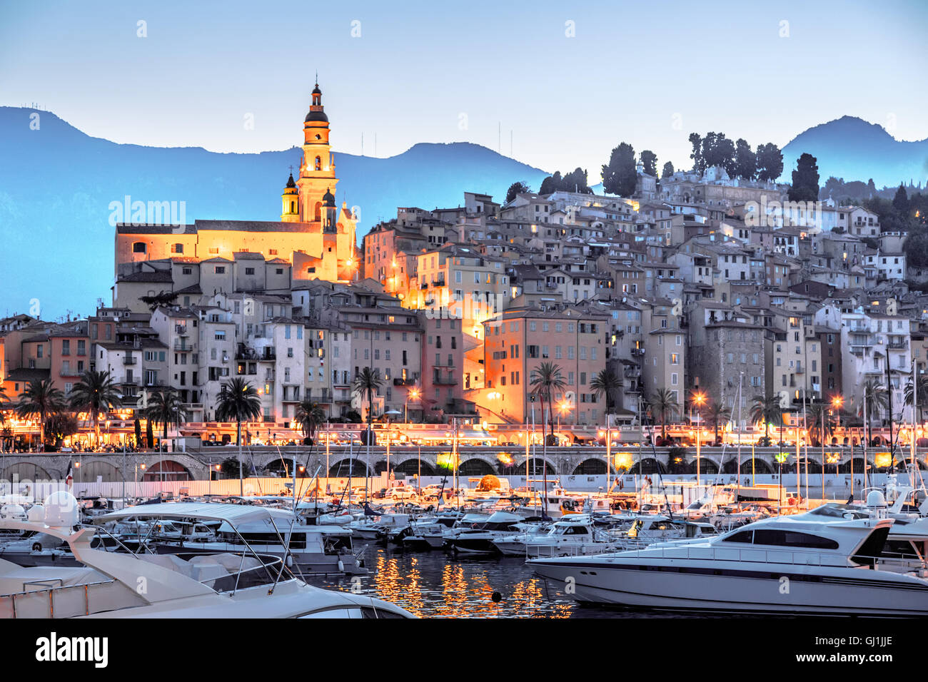 Riviera town Menton view with mountain and church in sunset Stock Photo