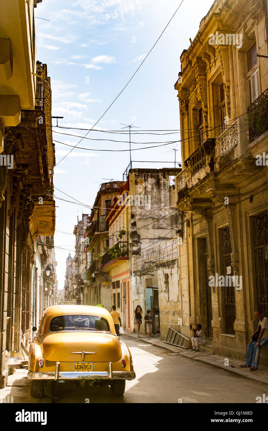 Rear view  shot of classic, vintage gold car on sunny day in old, colonial street, Havana, Cuba, 2013 Stock Photo