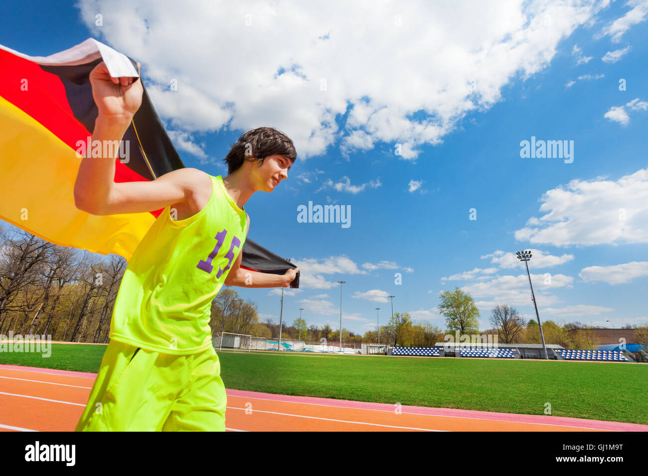 Sporty teenage boy running with flag of Germany Stock Photo Alamy