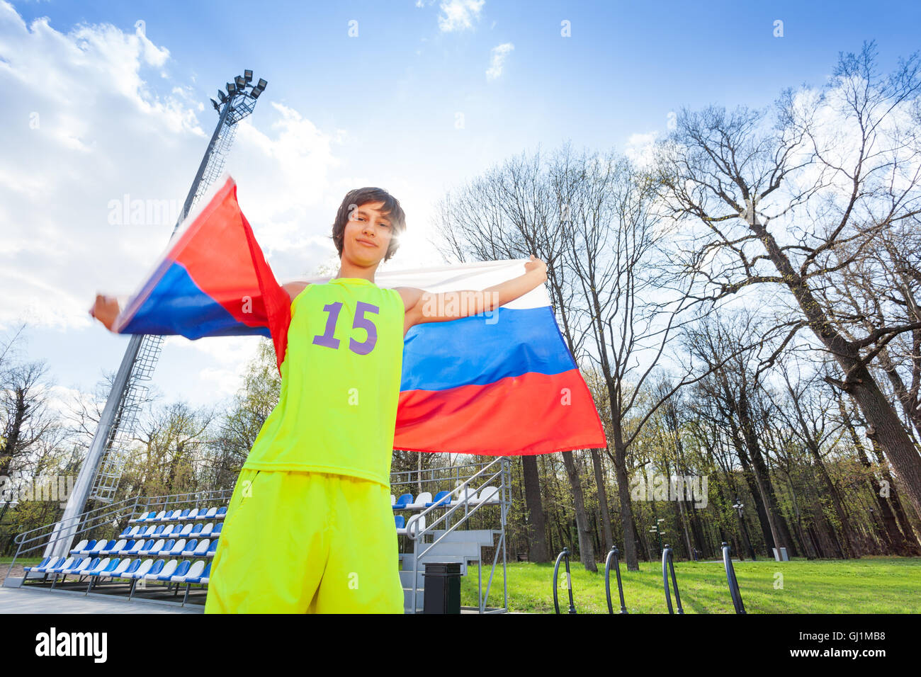 Portrait of teenage runner waving Russian flag Stock Photo