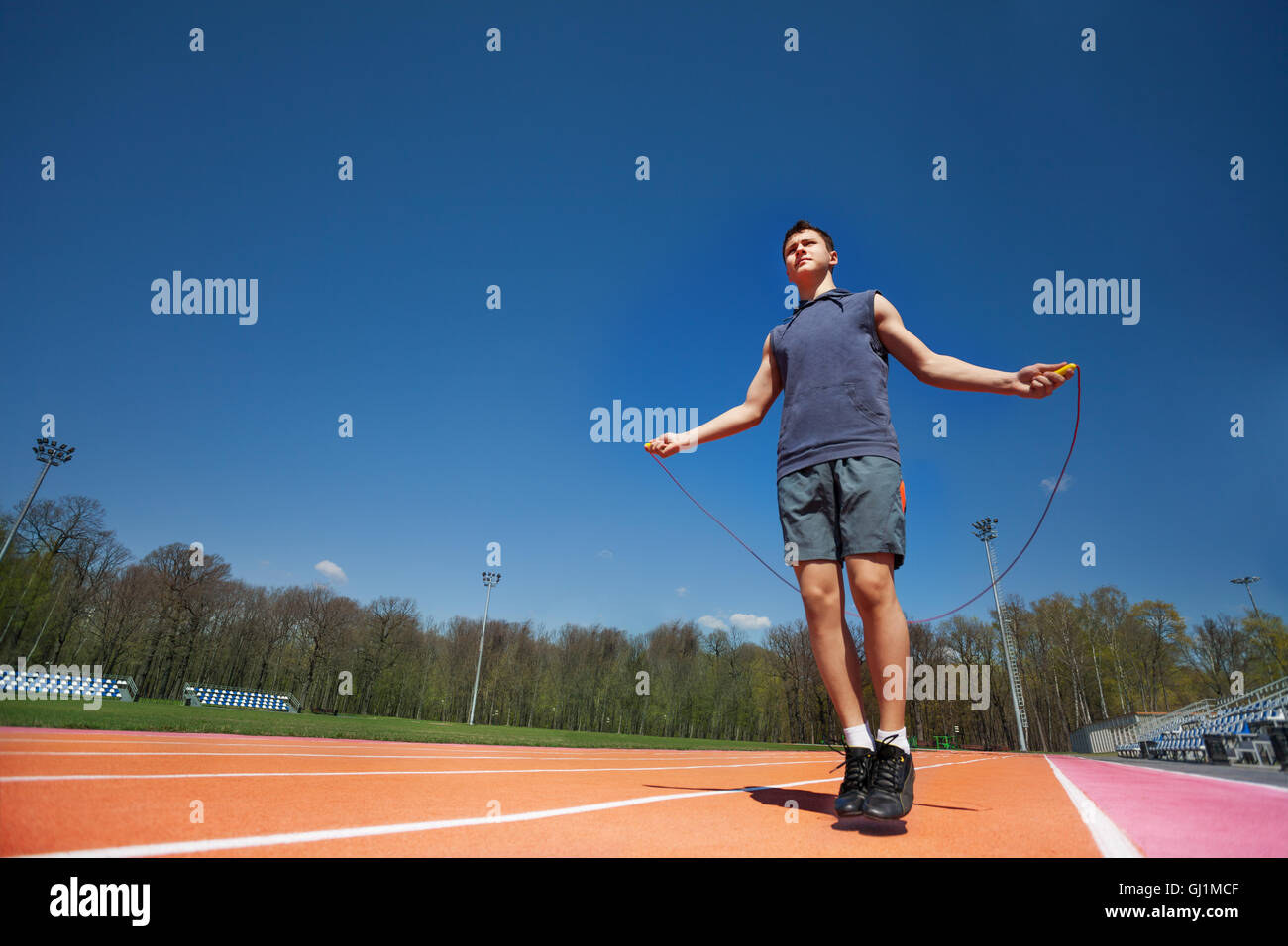 Active male athlete skipping the rope outside Stock Photo - Alamy