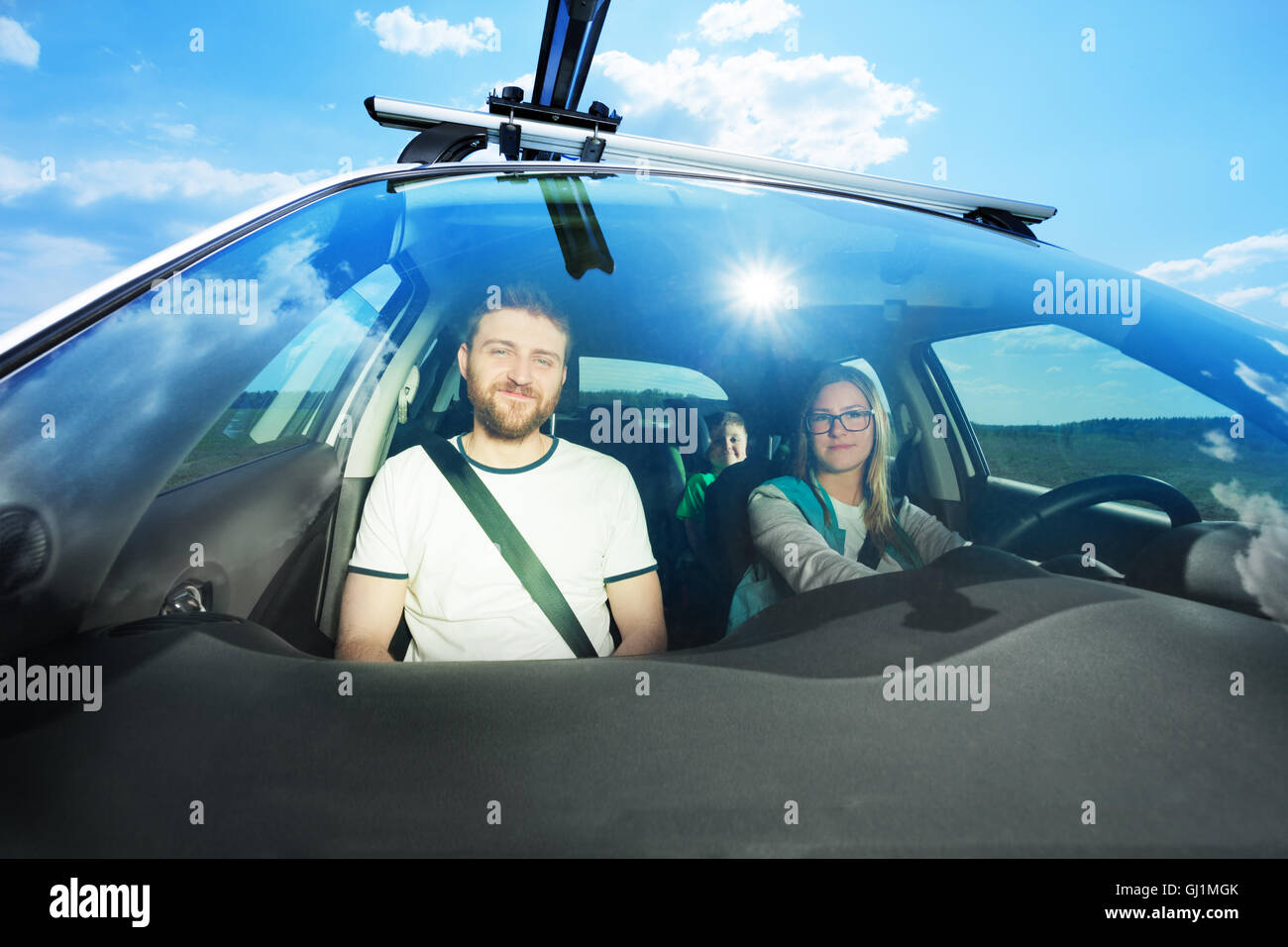 Happy young family during car trip on sunny day Stock Photo