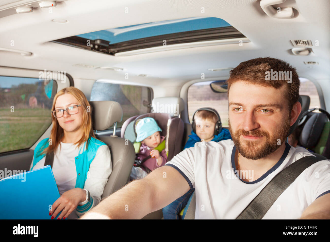 Young father driving his family car Stock Photo - Alamy