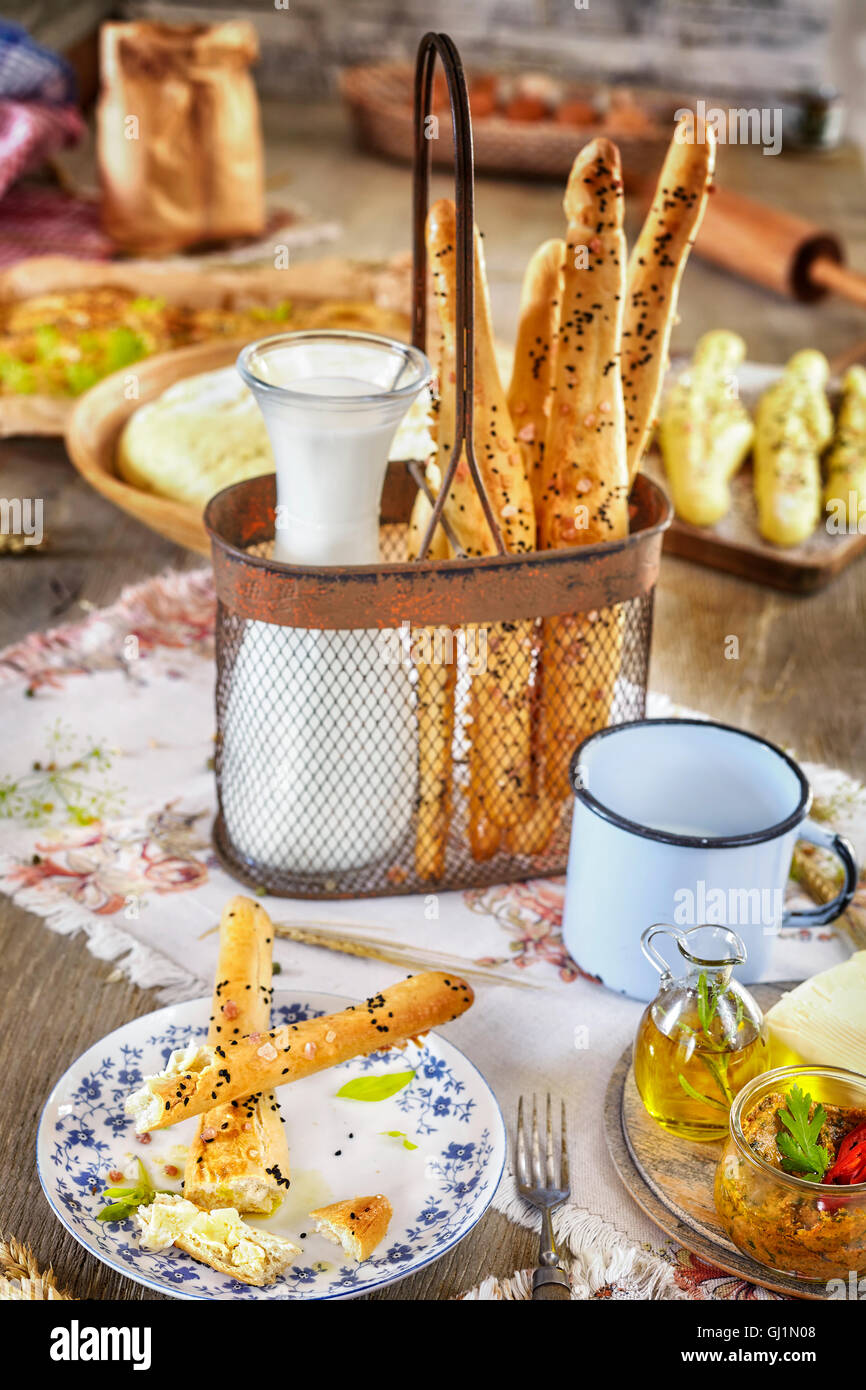 Bread sticks with milk, rustic setting on a wooden table. Stock Photo