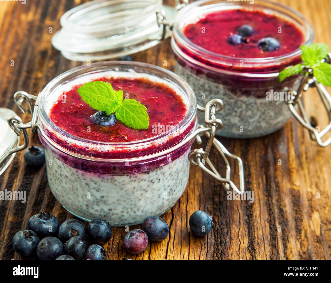 Blueberry puree with chia pudding in jars with mint leaves Stock Photo
