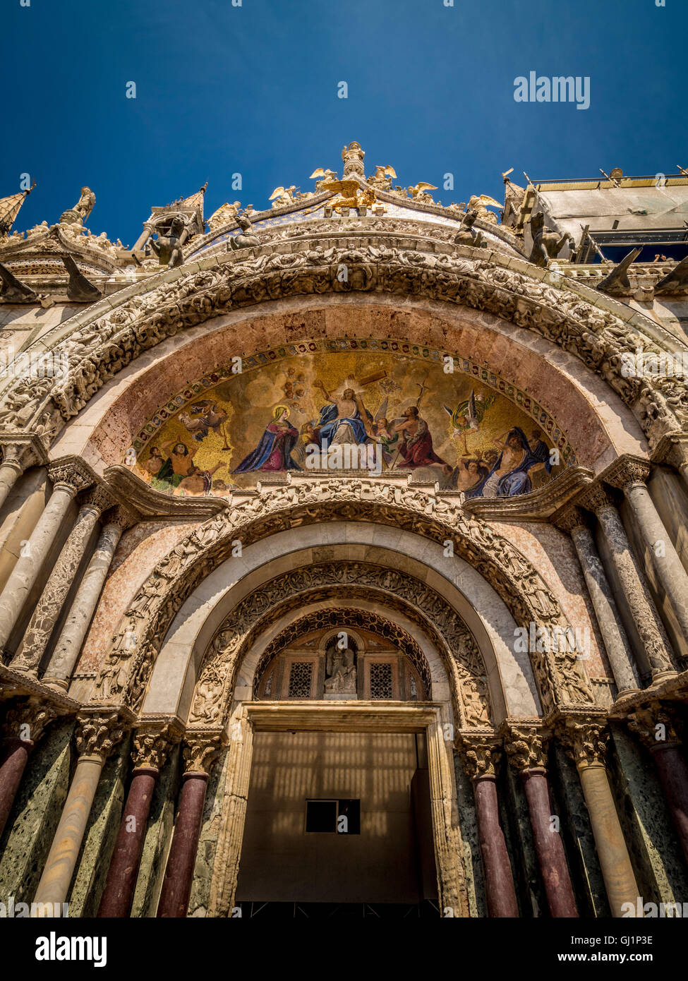 One of the five grand entrance portals of the west facade of  St Mark's basilica. Venice, italy. Stock Photo