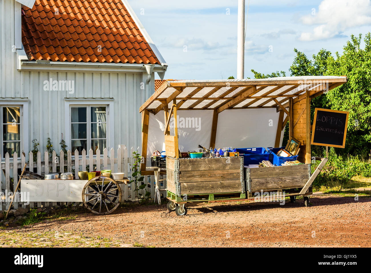 Pataholm, Sweden - August 9, 2016: Unmanned flea market (Loppis) stand with some old stuff. Payment is done by customer by use o Stock Photo