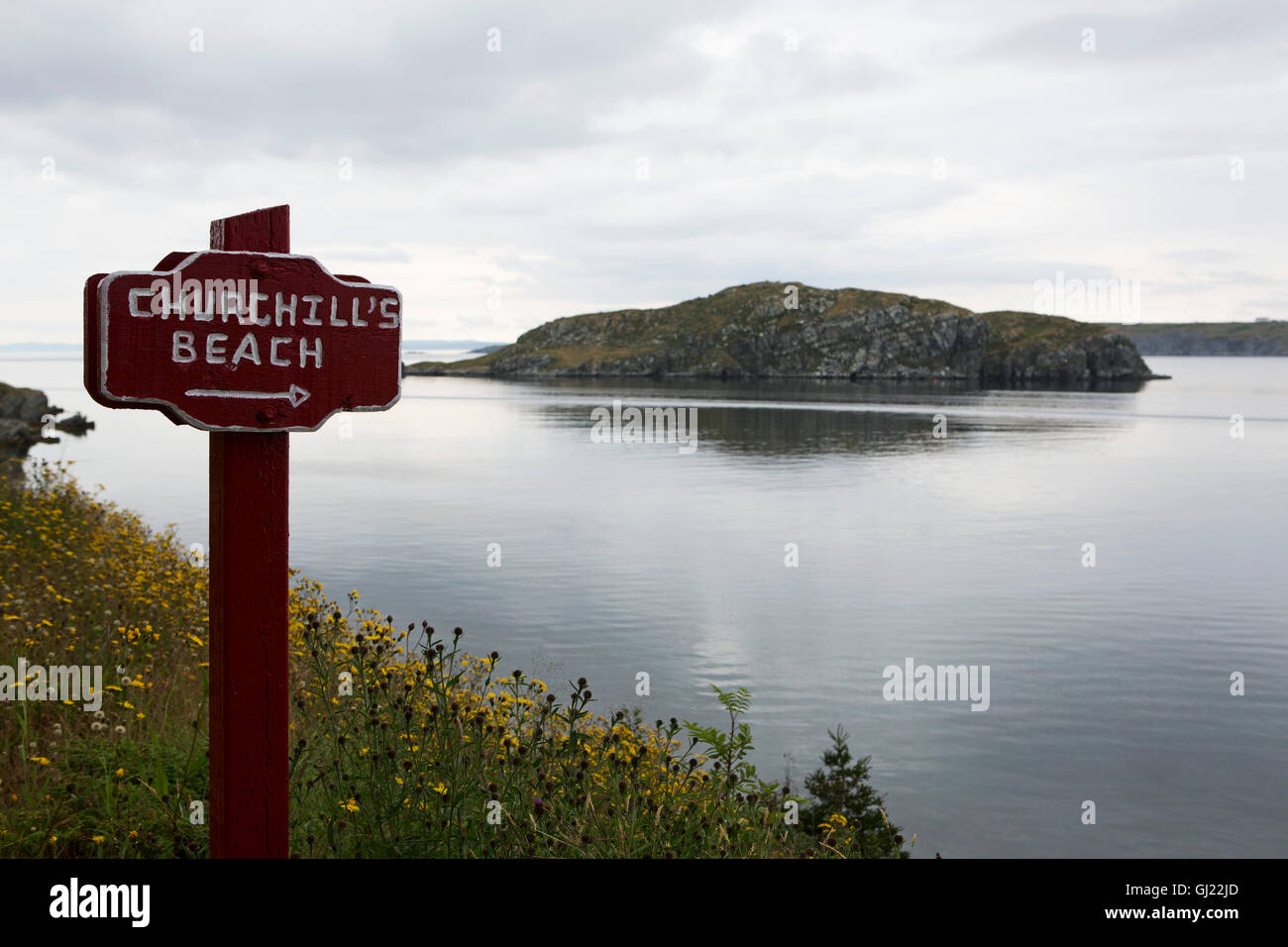 A sign for Churchill's Beach at Bay Roberts in Newfoundland and Labrador, Canada. Fergus Island stands off the shore. Stock Photo