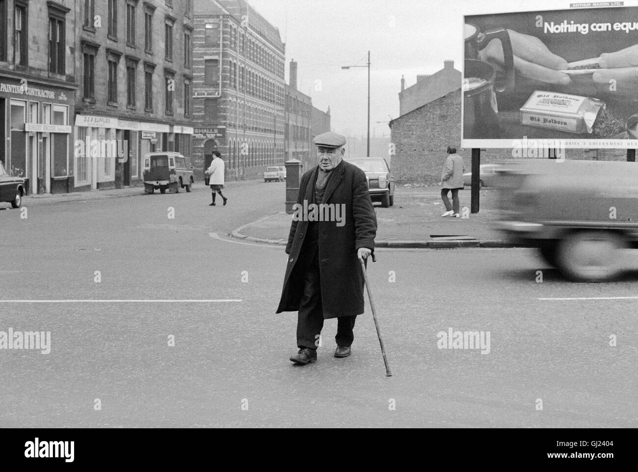 Old Man Crossing Road, Glasgow East End, 1971 approx Stock Photo