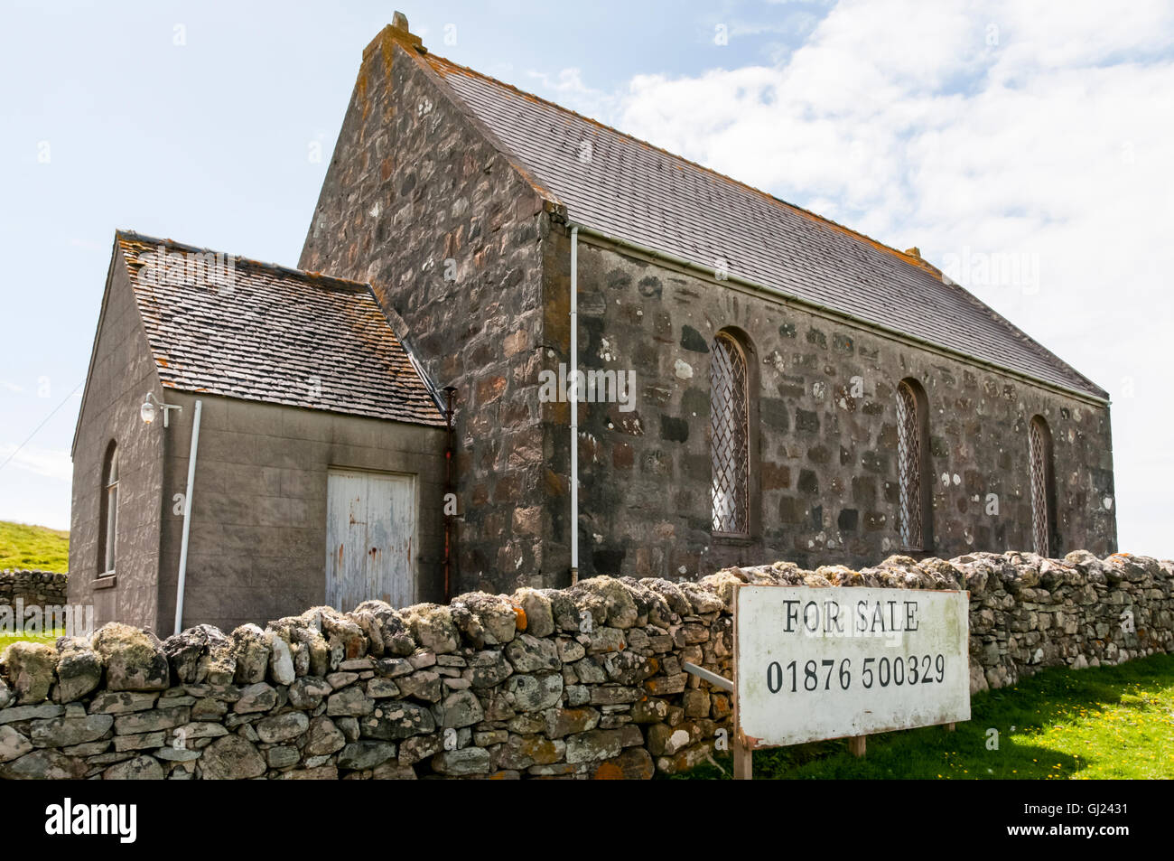 A For Sale sign on the former Cairinis parish church on North Uist in the Outer Hebrides. Stock Photo