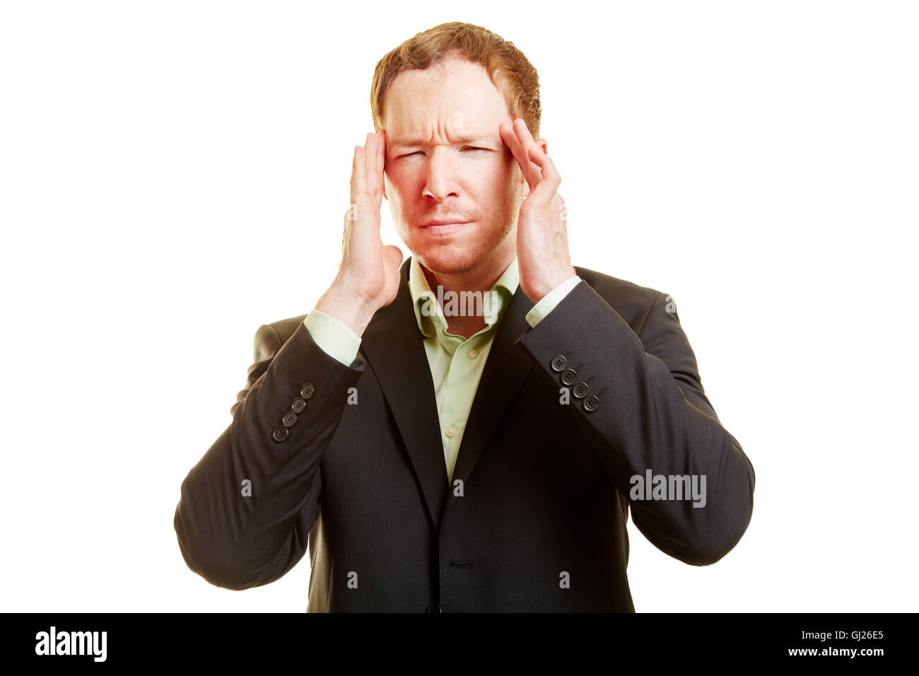 Man with migraine holding his hands on his temples and looking frustrated Stock Photo