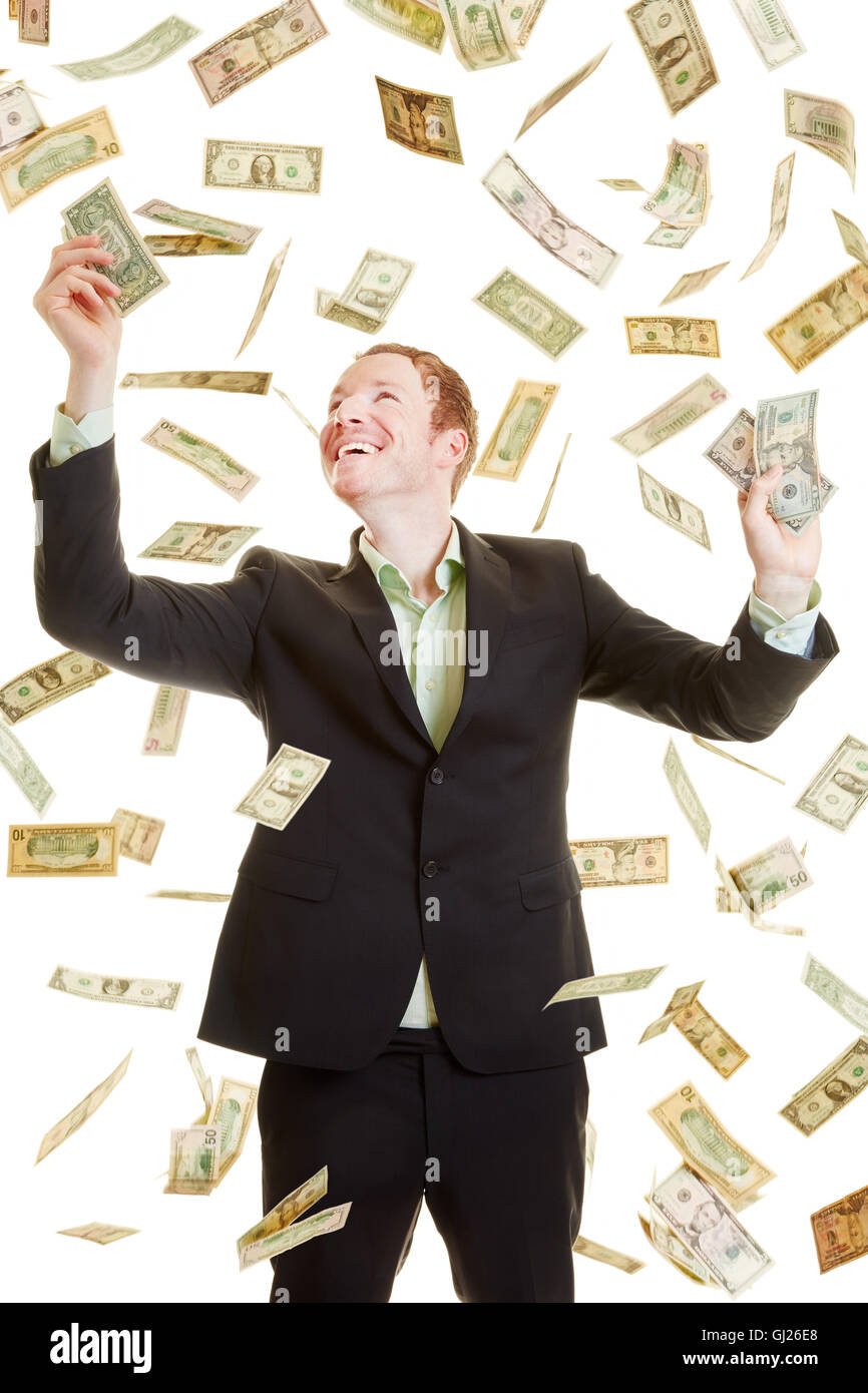 Happy businessman catching dollars under a dollar rain Stock Photo