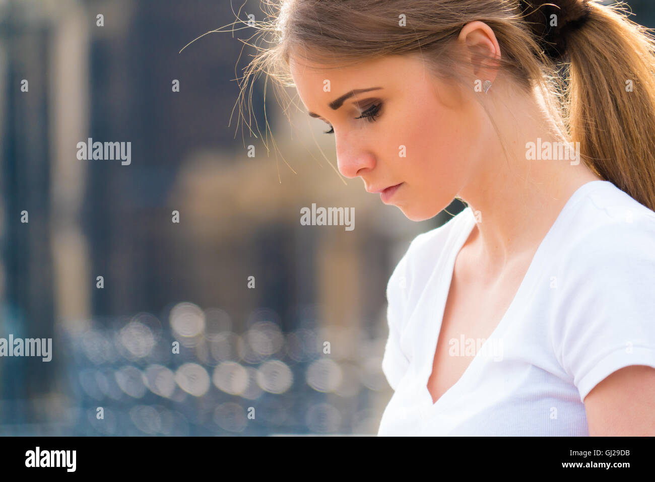 Outdoor Portrait young beautiful  woman, look down Stock Photo
