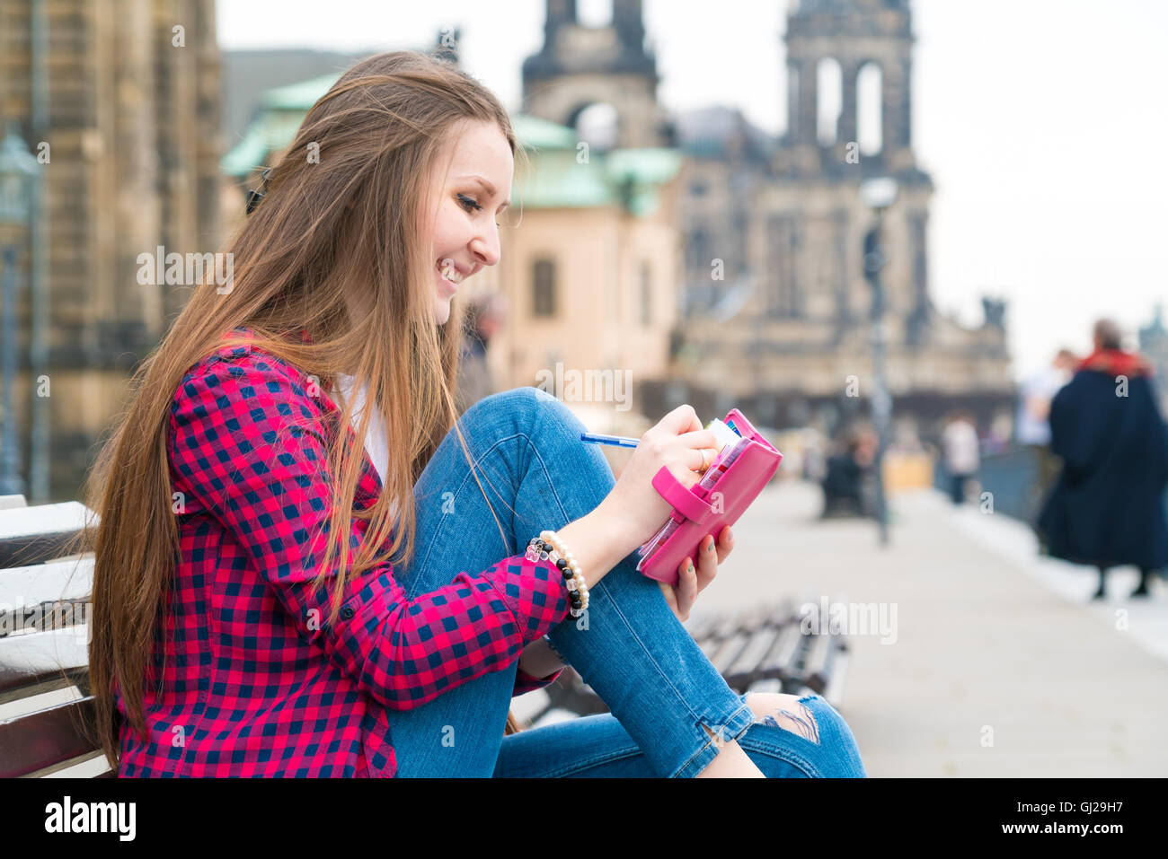 Woman tourist writes his impressions in a diary, Dresden, Germany Stock Photo