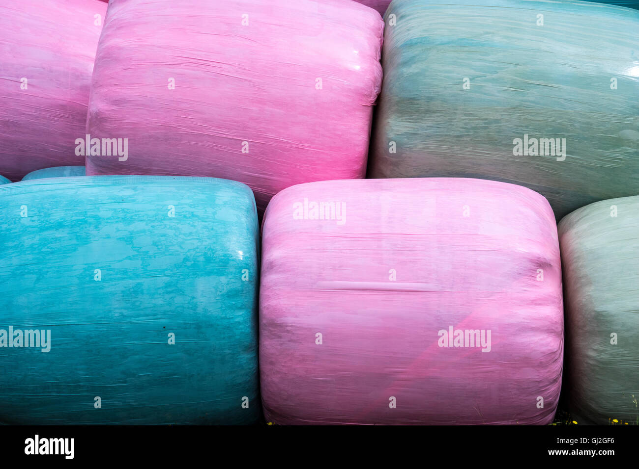 Close up of stack of pink, blue and green silage bags Stock Photo