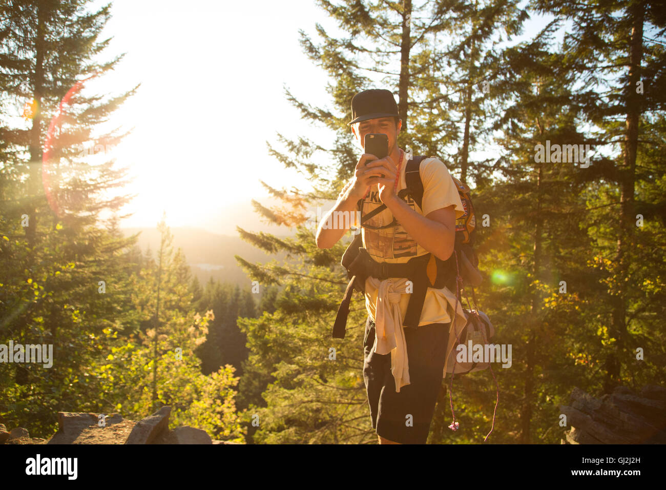 Male hiker taking smartphone selfie on forest ridge, Mount Hood National Forest, Oregon, USA Stock Photo