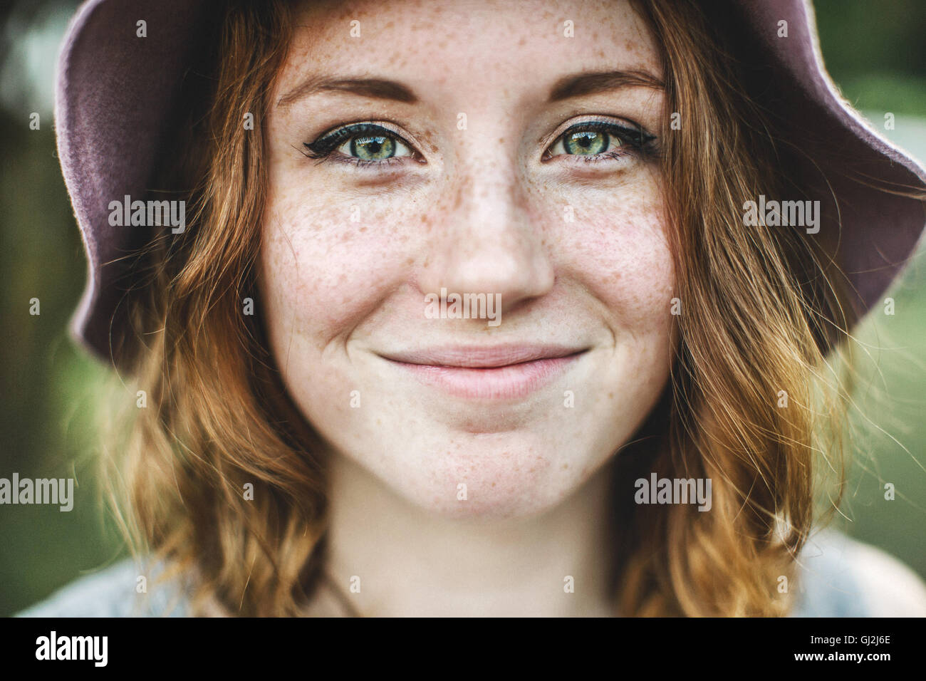 Portrait of freckled woman looking at camera smiling Stock Photo