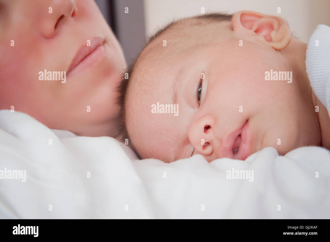 Baby boy sleeping on mothers chest Stock Photo Alamy