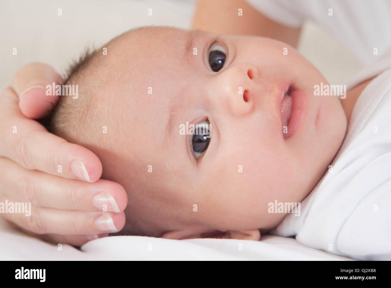 Mothers hand soothing baby boy Stock Photo