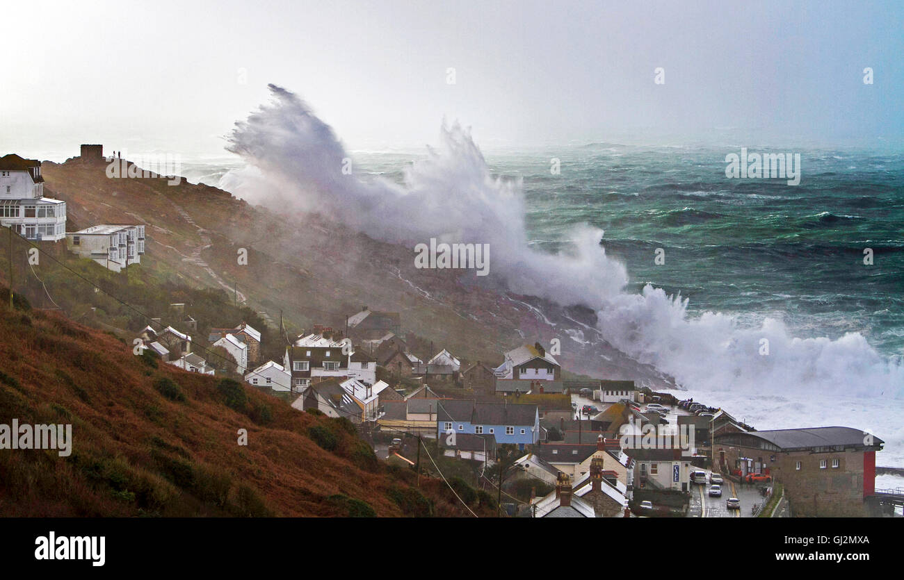 Massive storm waves cover a 200ft cliff at Sennen in Cornwall Stock Photo