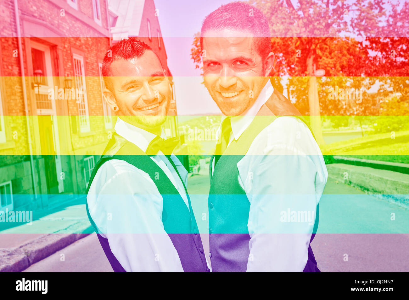 A Portrait of a loving gay male couple on their wedding day. The photo is taked on the Quebec city street. Stock Photo