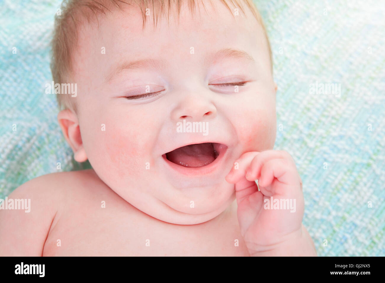 A young baby lay on Stock Photo Alamy