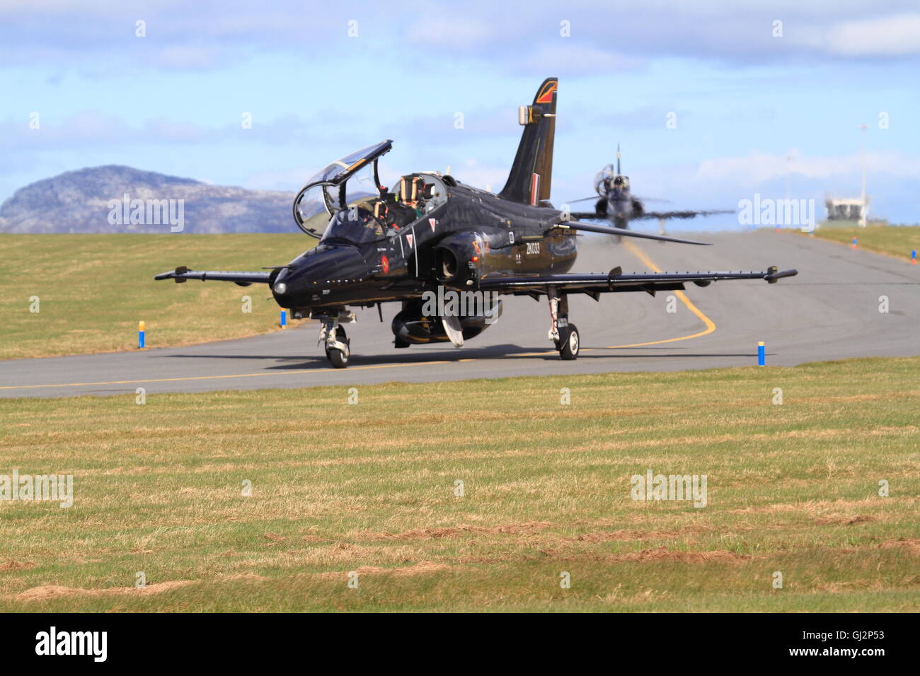 Royal Air Force Hawk training aircraft taxy to the main runway at RAF Valley ahead of a training flight. Stock Photo