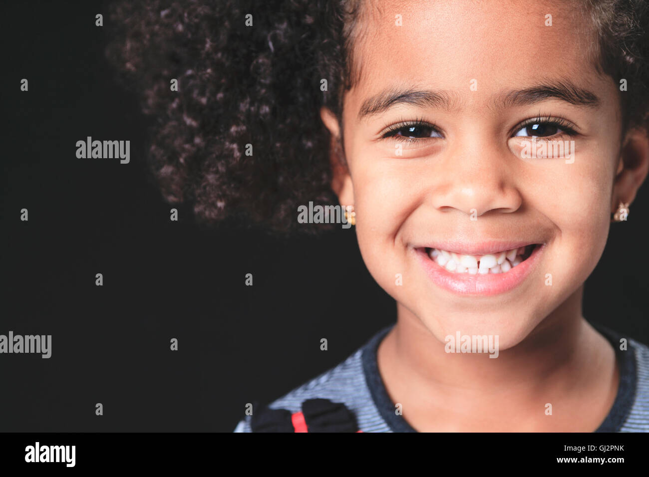 Portrait of a cute african american little girl, isolated on black ...